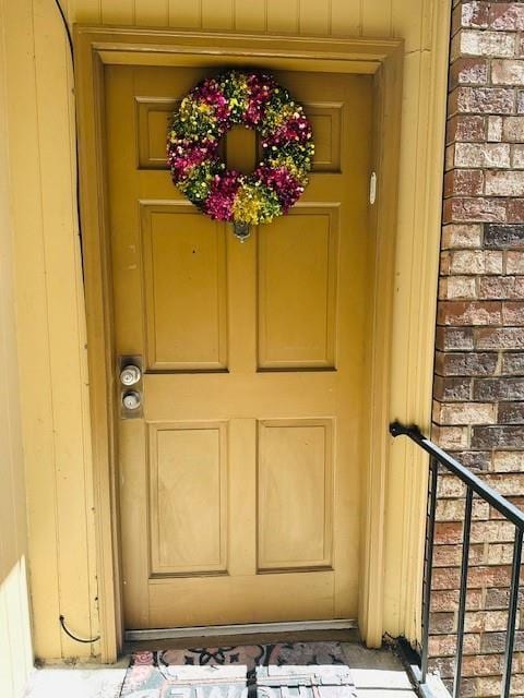 view of exterior entry with brick siding