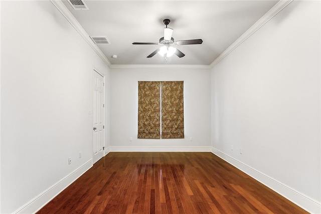 unfurnished room with baseboards, visible vents, dark wood-style flooring, and ornamental molding