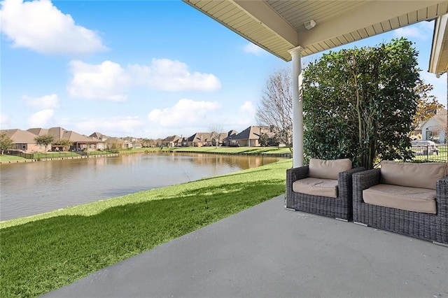 view of patio / terrace with a residential view and a water view