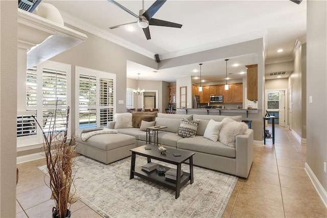 living area with light tile patterned floors, baseboards, ornamental molding, ceiling fan with notable chandelier, and recessed lighting