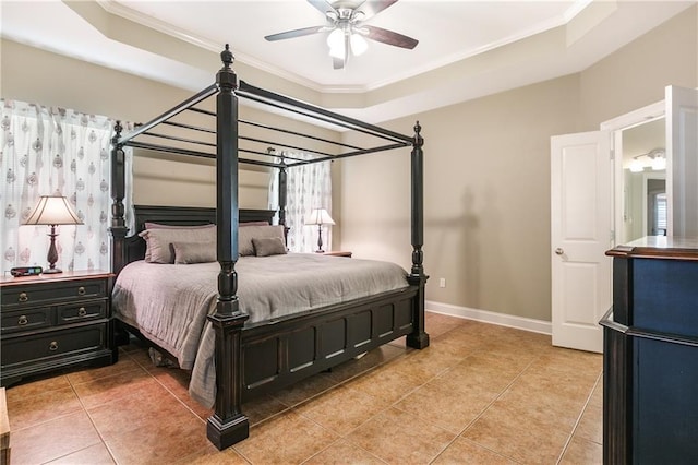 bedroom featuring ornamental molding, a raised ceiling, light tile patterned flooring, and baseboards