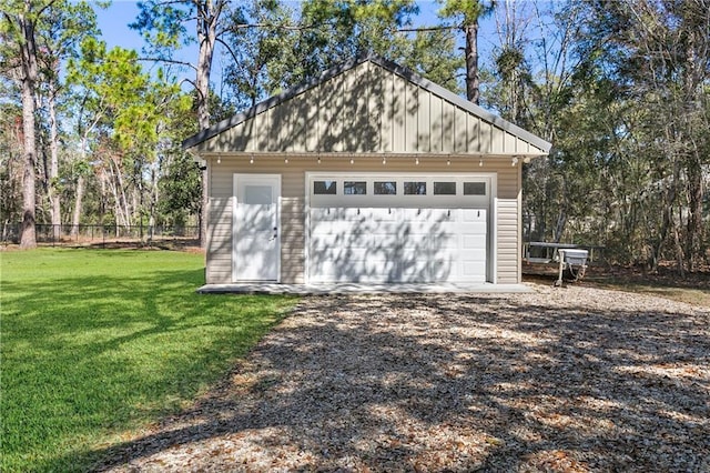 detached garage featuring fence