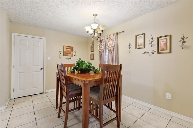 dining room featuring light tile patterned floors, a textured ceiling, and a notable chandelier