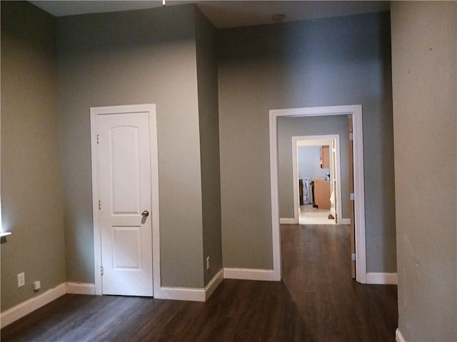 hall featuring wood finished floors and baseboards