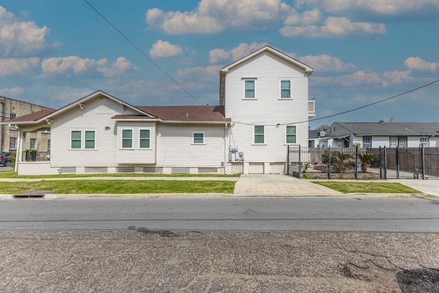 view of front of home featuring fence and a front lawn