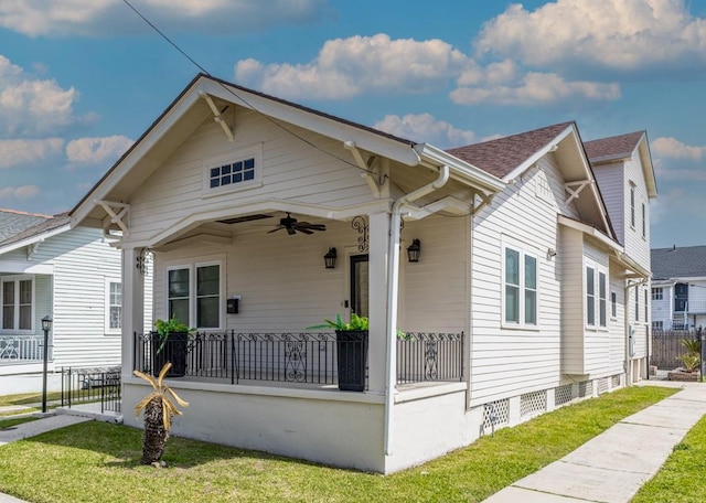 bungalow-style home with ceiling fan, covered porch, fence, crawl space, and a front yard