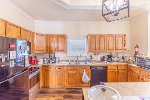 kitchen featuring ornamental molding, light countertops, a sink, and black appliances