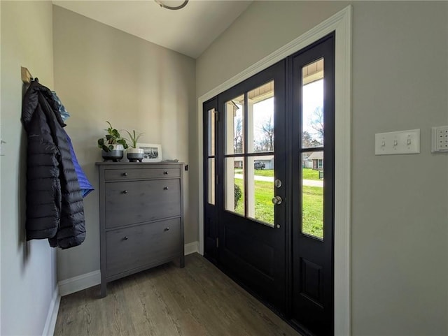 doorway to outside featuring french doors, wood finished floors, and baseboards