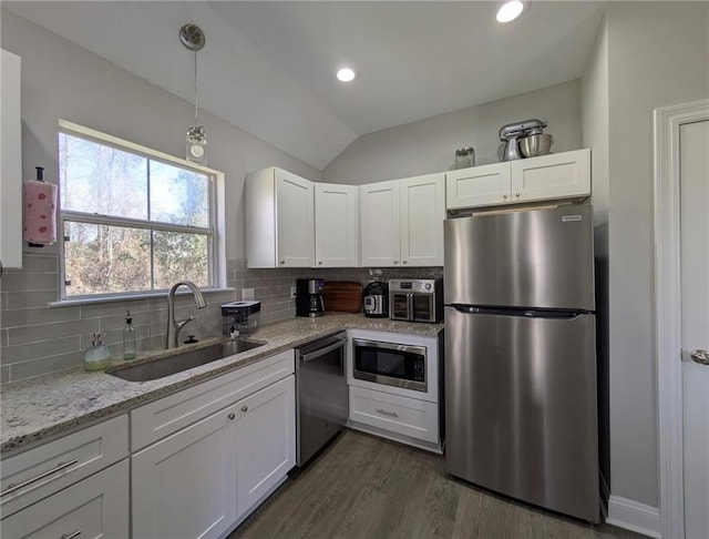 kitchen featuring stainless steel appliances, a sink, and white cabinetry