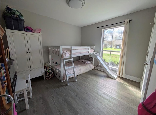 bedroom with baseboards and wood finished floors