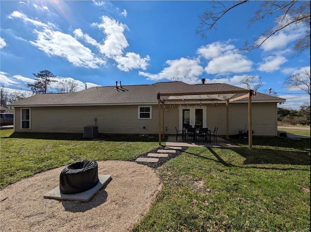 back of property featuring a patio area, central AC unit, a lawn, and french doors