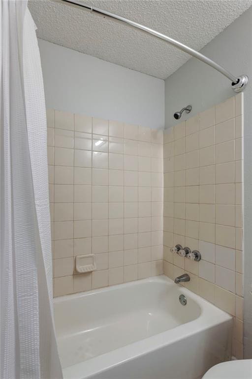 full bath with shower / tub combo, a textured ceiling, and toilet