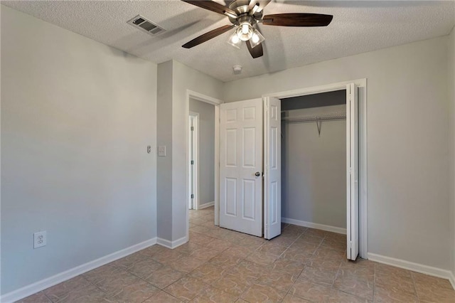 unfurnished bedroom featuring visible vents, ceiling fan, a textured ceiling, and baseboards