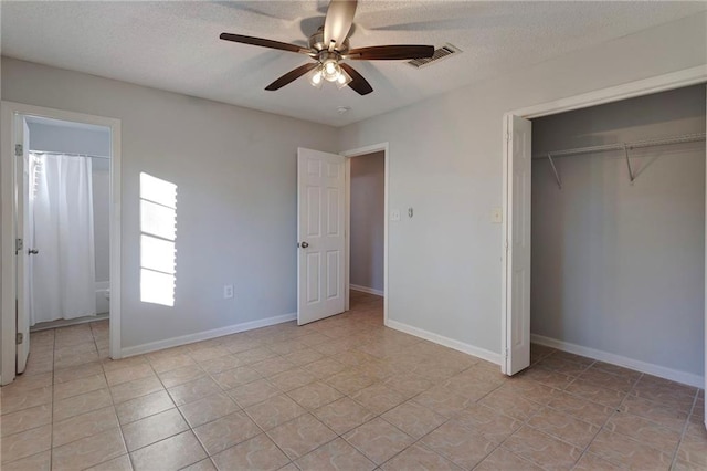 unfurnished bedroom with a textured ceiling, a closet, visible vents, and baseboards