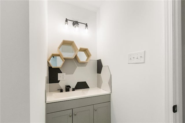 bathroom with decorative backsplash and vanity