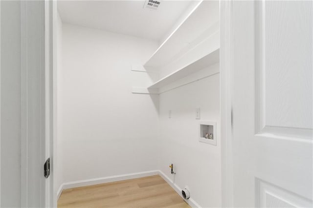 laundry area featuring visible vents, gas dryer hookup, washer hookup, laundry area, and light wood-style flooring