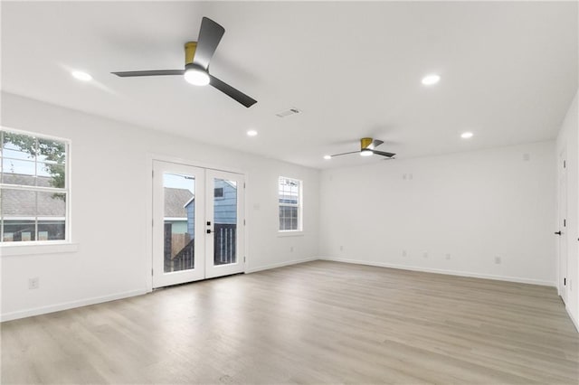 empty room featuring recessed lighting, french doors, and light wood finished floors