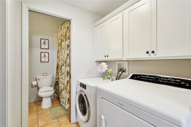 laundry area with light tile patterned floors, laundry area, and washer and clothes dryer