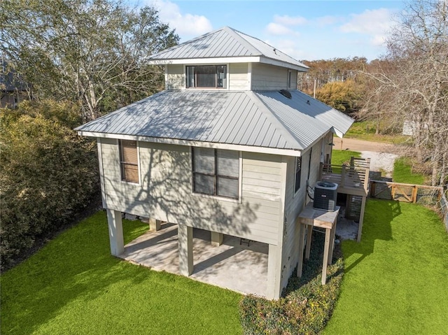 view of outdoor structure featuring fence, driveway, and central air condition unit