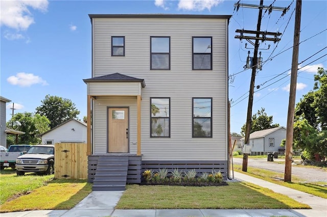 view of front of property featuring a front lawn and fence