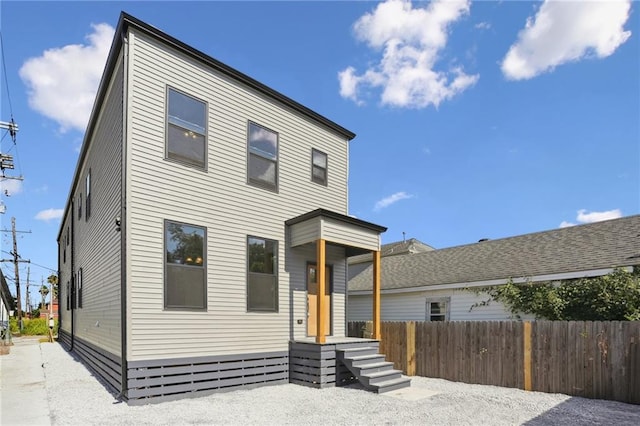 contemporary house featuring fence