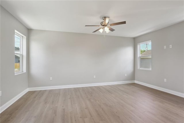 empty room featuring light wood-style floors, baseboards, and ceiling fan