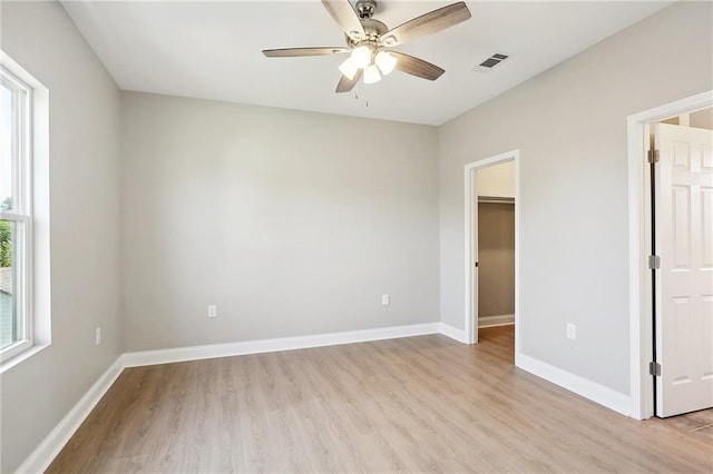 unfurnished bedroom featuring light wood finished floors, visible vents, and baseboards