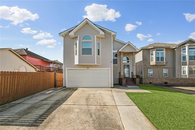 view of front of property with an attached garage, concrete driveway, a front yard, and fence