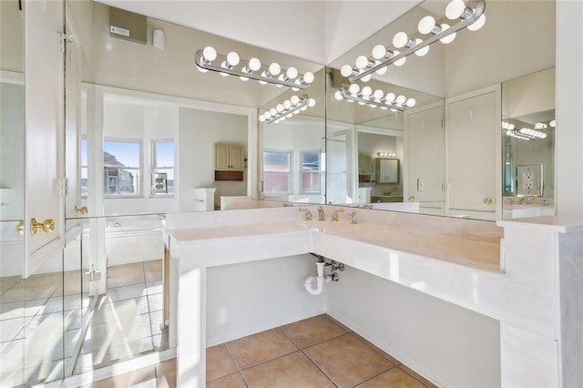 bathroom featuring tile patterned flooring, vanity, and a healthy amount of sunlight