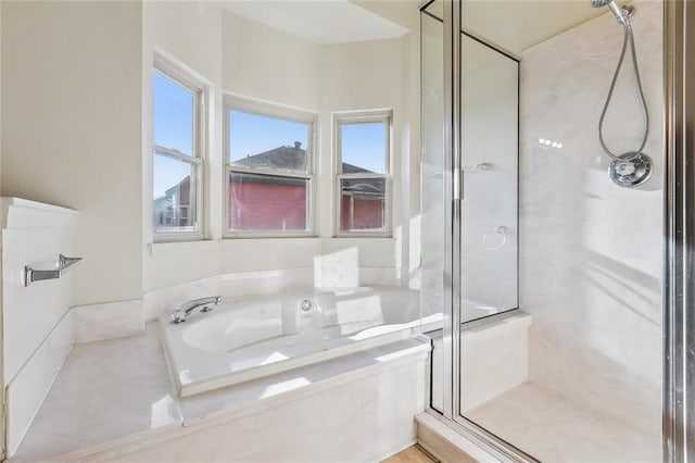 full bathroom featuring a shower stall and a bath