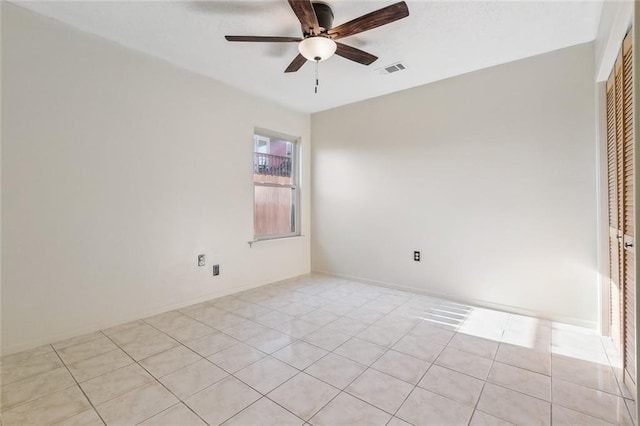 unfurnished room featuring light tile patterned floors, ceiling fan, visible vents, and baseboards