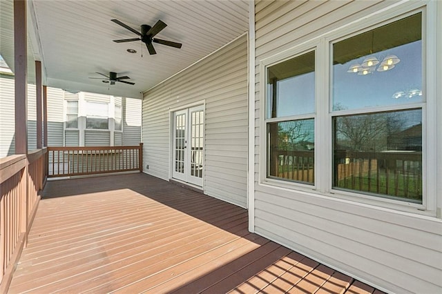 wooden deck featuring a ceiling fan and french doors