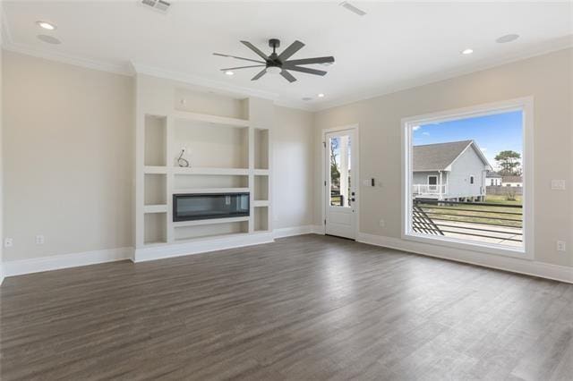 unfurnished living room featuring built in shelves, visible vents, baseboards, dark wood-style floors, and a glass covered fireplace