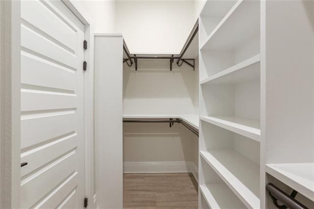 spacious closet with wood finished floors