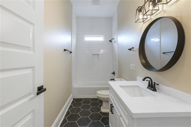 full bathroom with bathing tub / shower combination, toilet, vanity, tile patterned flooring, and baseboards