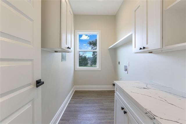 laundry area featuring dark wood-style floors, washer hookup, cabinet space, hookup for an electric dryer, and baseboards