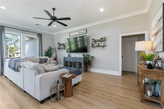 living room featuring visible vents, crown molding, light wood-style flooring, and baseboards