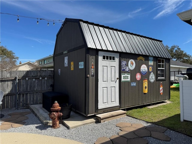 view of outbuilding featuring an outbuilding and fence