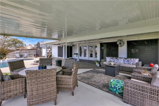 view of patio / terrace featuring a fenced in pool, french doors, outdoor lounge area, outdoor dining space, and fence