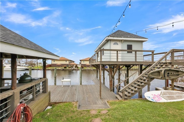 view of dock with a water view, stairway, and a yard