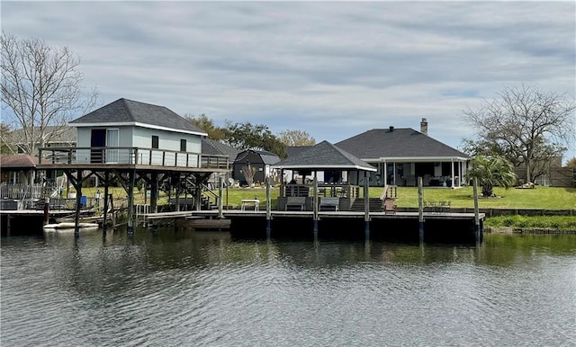 dock area with stairway, a lawn, and a deck with water view