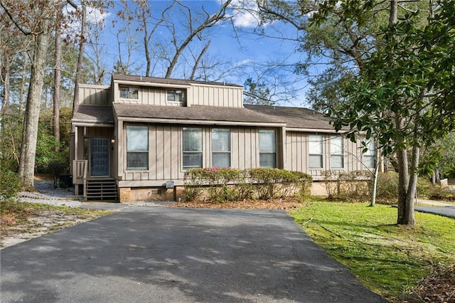 view of front of house featuring a front lawn and board and batten siding