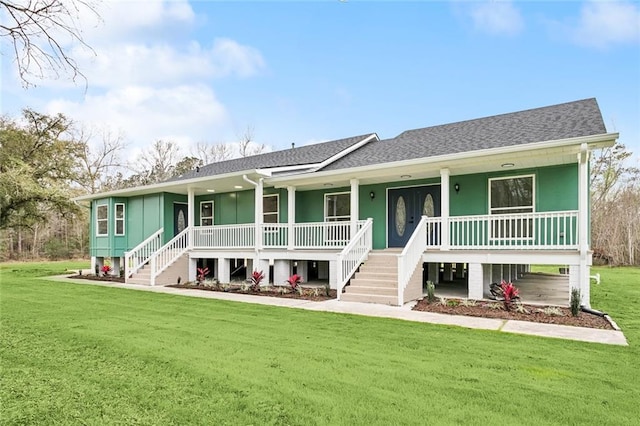 ranch-style home featuring a porch, a shingled roof, a front lawn, and stairs