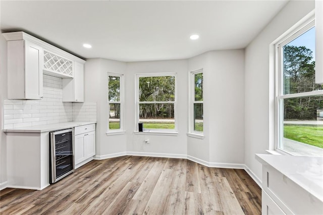 42224 Surrey Ln, Slidell, LA 70461 - kitchen with wine cooler, light countertops, white cabinetry, tasteful backsplash, and recessed lighting