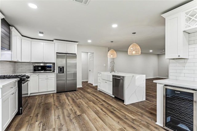 kitchen featuring dark wood-style floors, wine cooler, stainless steel appliances, and a sink