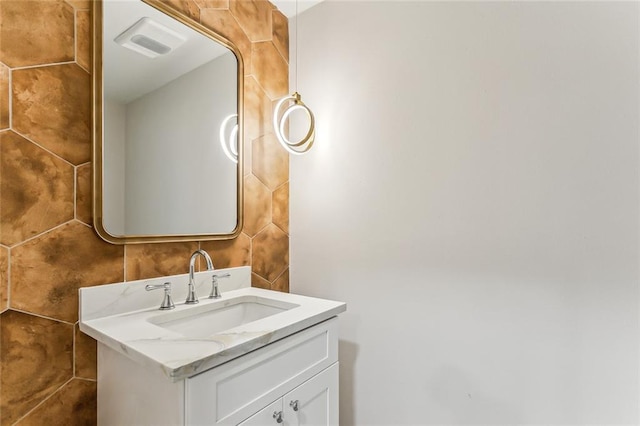 bathroom featuring tile walls and vanity