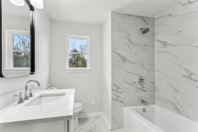 bathroom with baseboards, toilet, marble finish floor, bathtub / shower combination, and vanity