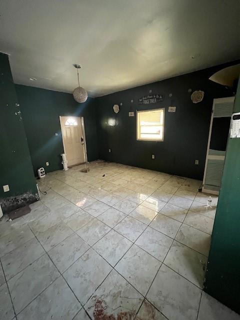 unfurnished dining area featuring light tile patterned flooring