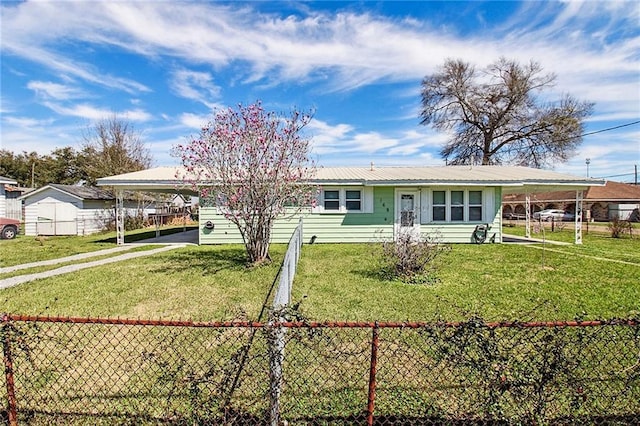 view of front of property with an attached carport, fence, and a front lawn