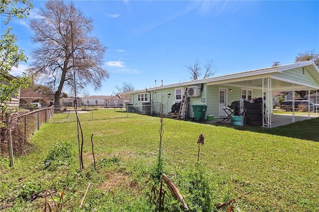 view of yard with a carport and a fenced backyard